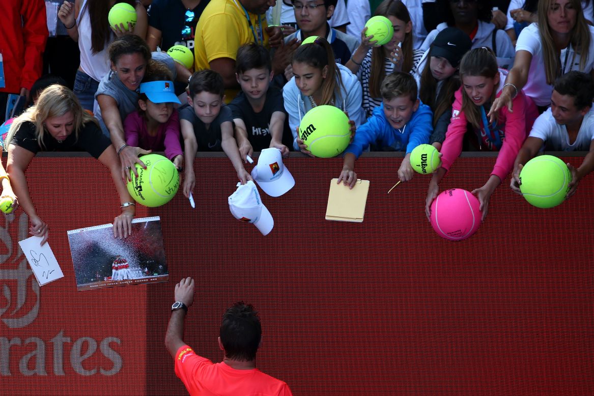 Wawrinka signs autographs after the match. The win was the 400th of his career.