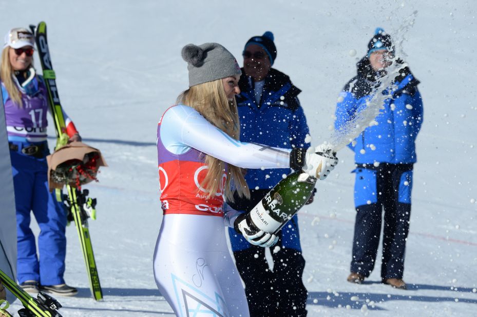 A delighted Vonn celebrates by spraying champagne over her bystanders.