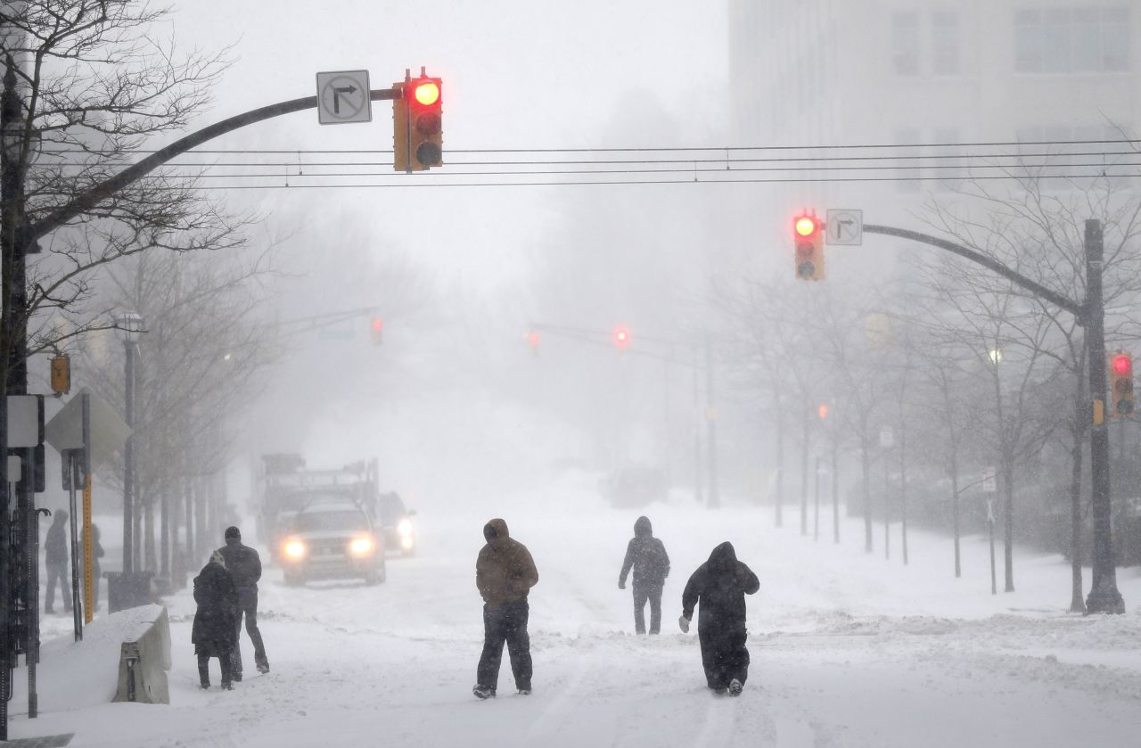 People make their way down a street in Jersey City, New Jersey, on January 23.