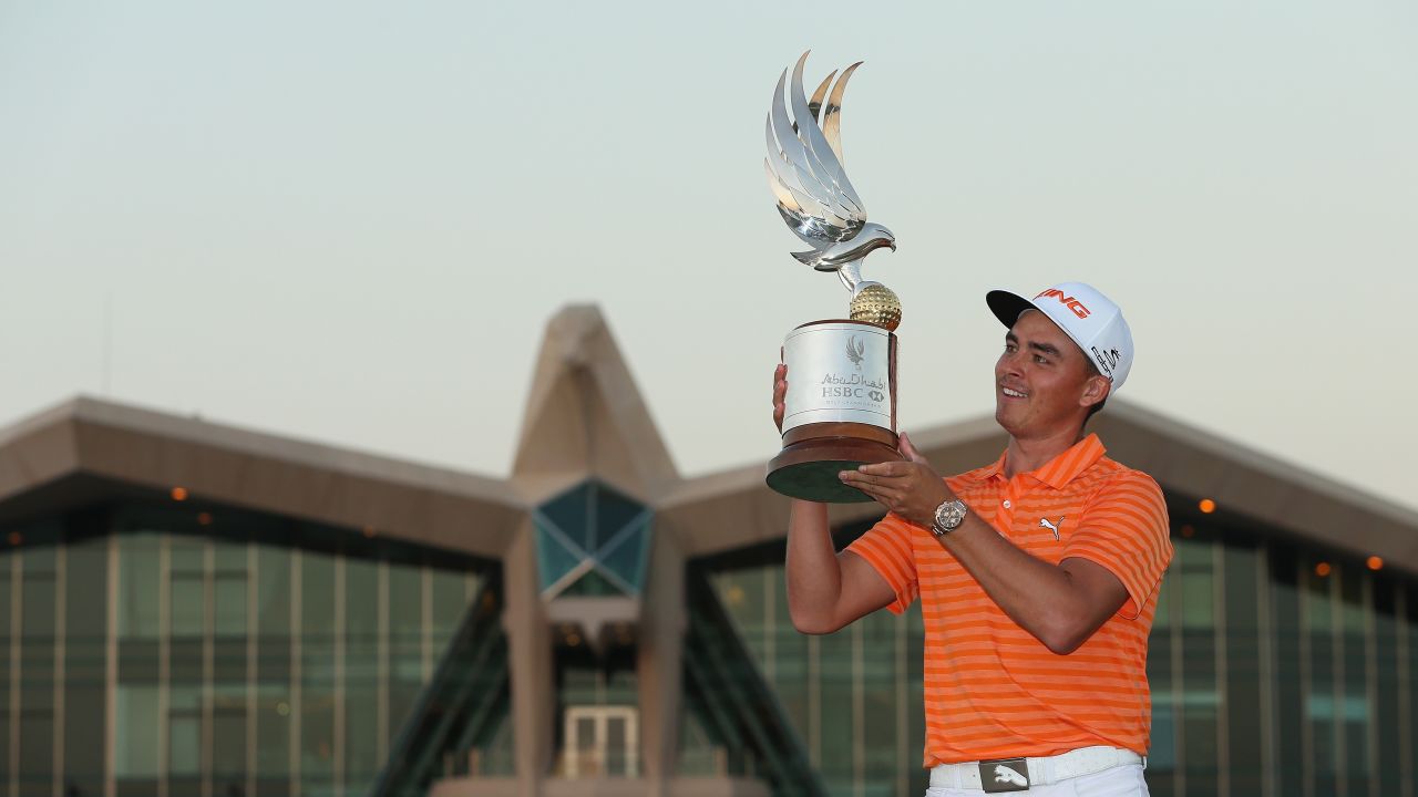Rickie Fowler poses with the winning trophy after claiming the Abu Dhabi Championship.