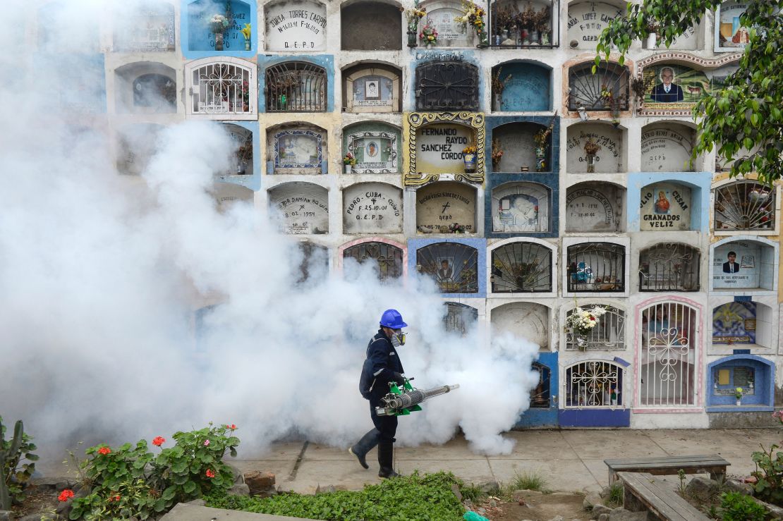 A worker fumigates against Zika virus carrying mosquitoes in Peru.