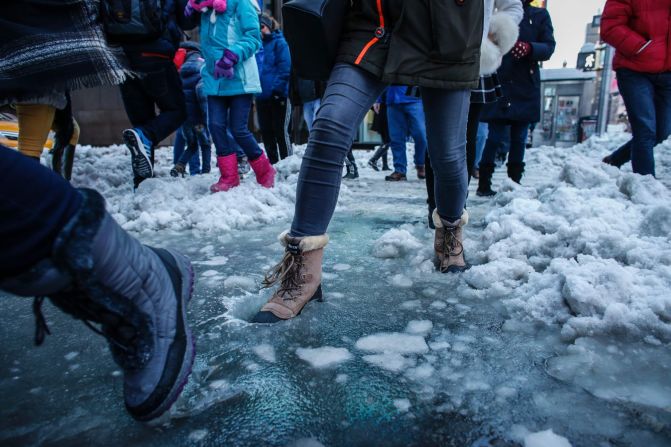 People cross a snow- and slush-covered street in New York on January 24.