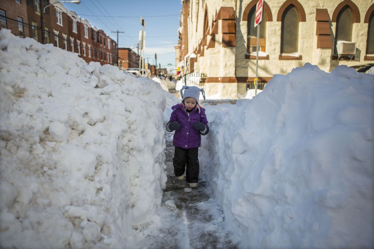 Beatrice Evangeline, 3, walks through a narrow shoveled-out path in Philadelphia on January 24.