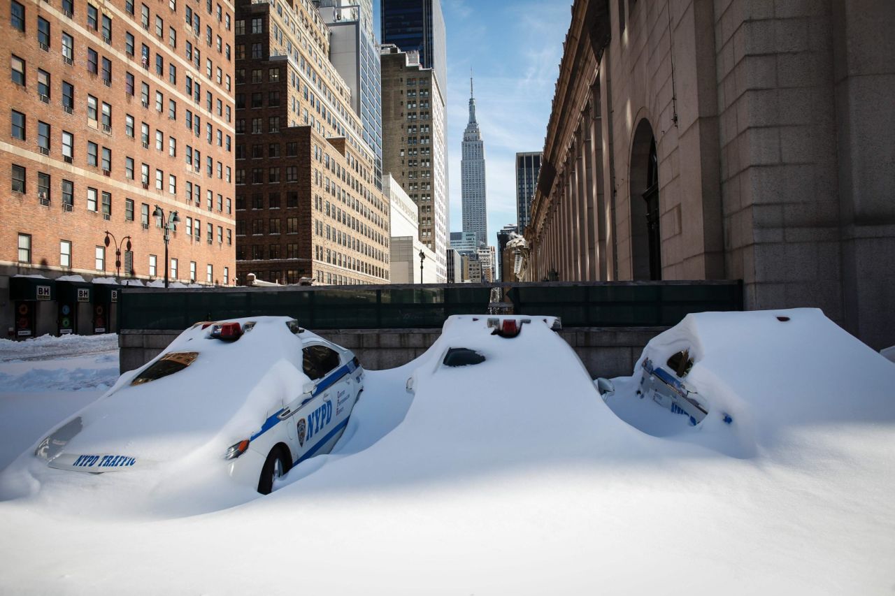 Police cars remain covered in snow in New York on January 24. 