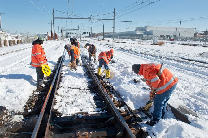 Workers clear snow from Long Island Railroad tracks on January 24.