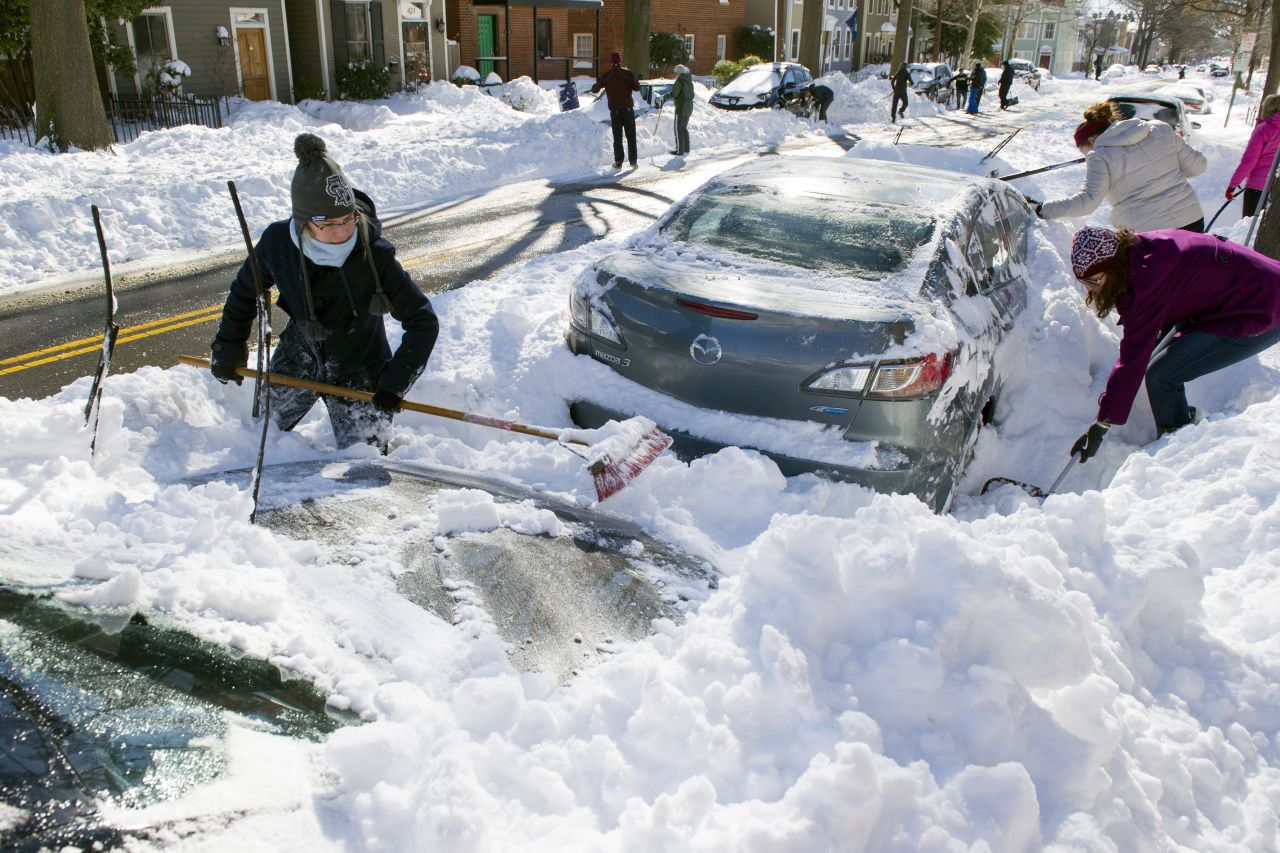 People dig out their cars in Alexandria, Virginia, on January 24.