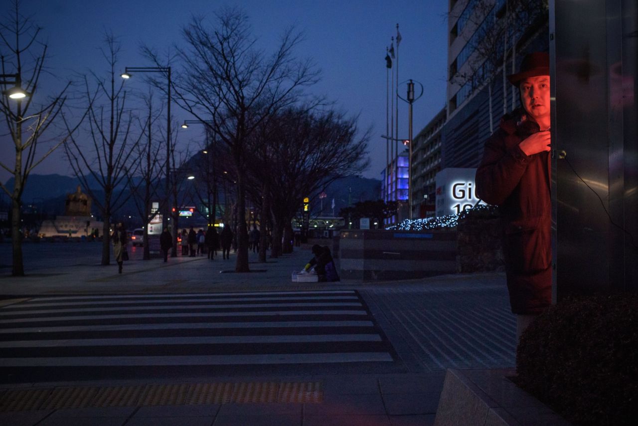 A man stands at a street-side heater in Seoul on January 21, with the mercury falling to a staggering minus 18 degrees Celsius, or 0 degrees Fahrenheit. More than 90,000 people were stranded on the South Korean resort island of Jeju when its airport was closed for two nights from Saturday because of strong wind and heavy snow.
