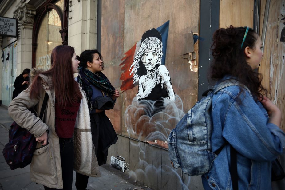 New artwork by street artist Banksy depicts a young girl from the musical Les Miserables with tears in her eyes as teargas moves towards her. It is the artist's latest work which aims to confront confronting the refugee crisis. Discover more...