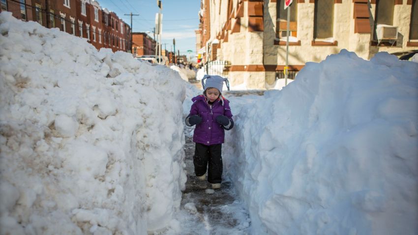 PHILADELPHIA, PENNSYLVANIA  - JANUARY 24:  Beatrice Evangeline, 3,  walks through a narrow shoveled path on January 24, 2016  in Philadelphia, Pennsylvania. Millions of people are digging themselves out after a record snow storm affected most of the Mid Atlantic States. (Photo by Jessica Kourkounis/Getty Images)