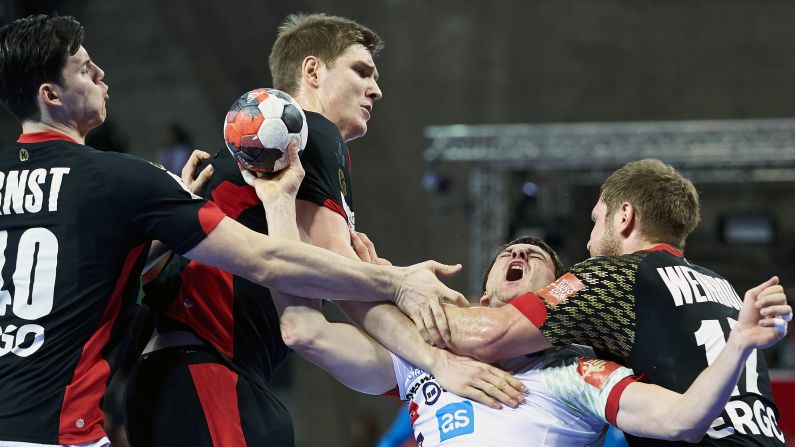 Slovenian handball player Sebastian Skube is met by three German players during a European Championship match on Wednesday, January 20.