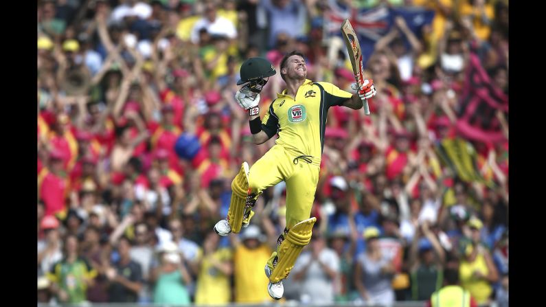 Australian cricketer David Warner jumps into the air after hitting a century against India on Saturday, January 23. But India won the match by six wickets -- its only victory in the five-match series played in Australia.