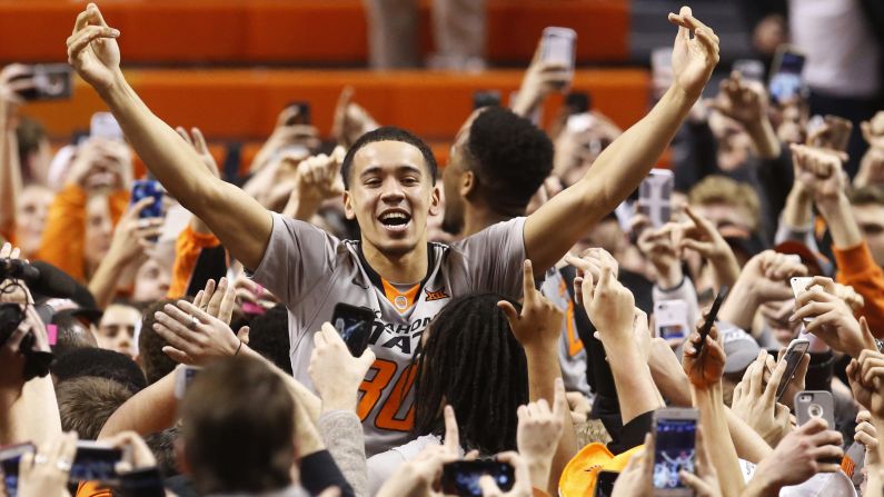 Oklahoma State guard Jeffrey Carroll celebrates with fans after the Cowboys defeated Kansas on Tuesday, January 19.