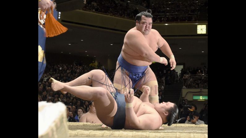 Ozeki Kotoshogiku throws Goeido on Sunday, January 24, to win the New Year Grand Sumo Tournament in Tokyo. He is the first Japanese wrestler to win an Emperor's Cup since 2006.