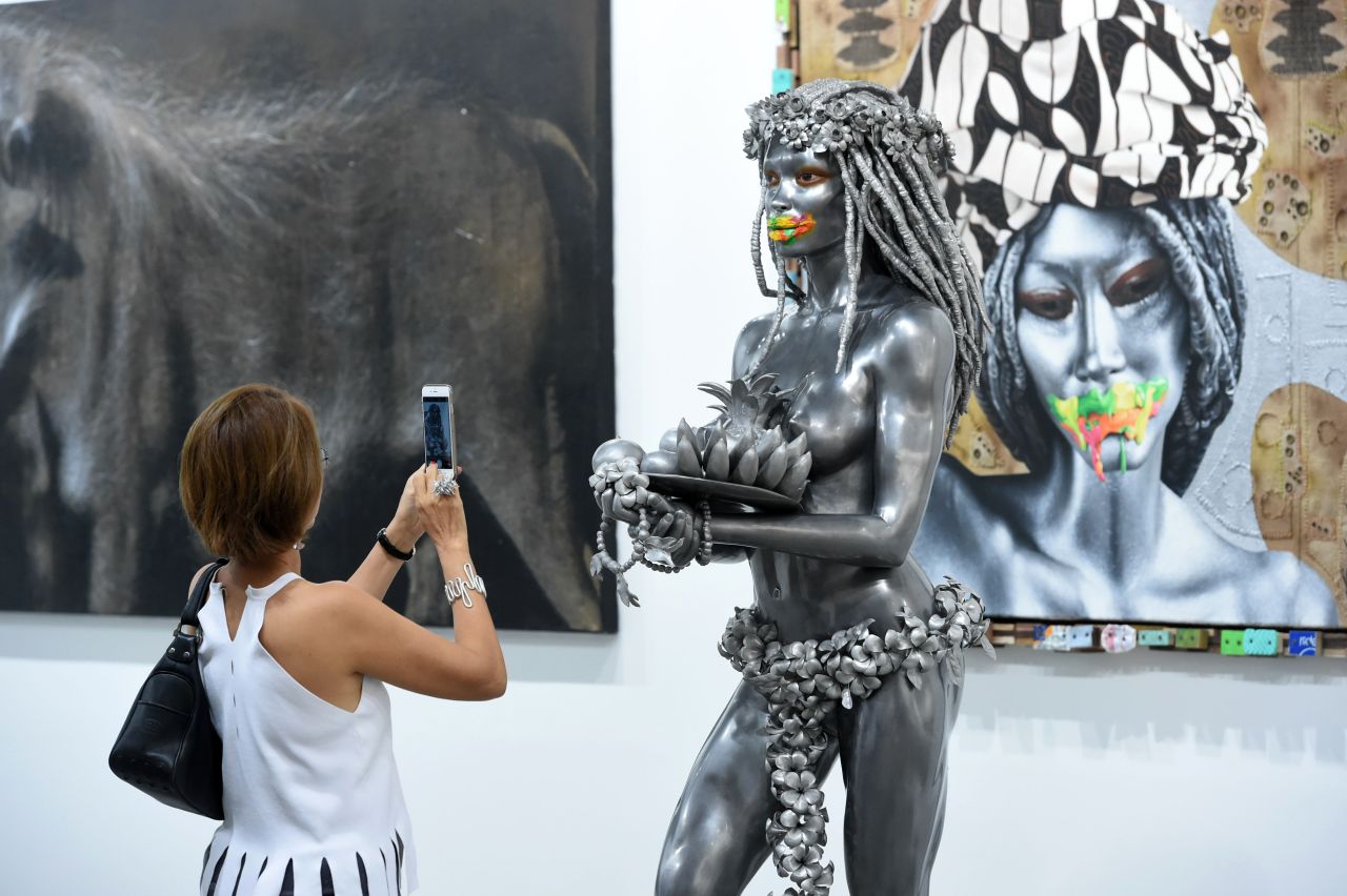 A visitor takes a photograph of an art installation at the Art Stage fair in Singapore in 2016.