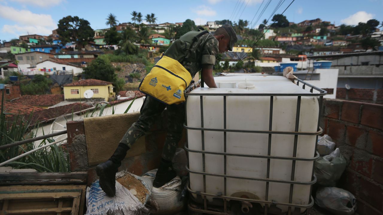 A Brazilian soldier inspects a home in Recife on Monday, January 25, while canvassing the neighborhood and attempting to eradicate the larvae of mosquitoes linked to the virus.