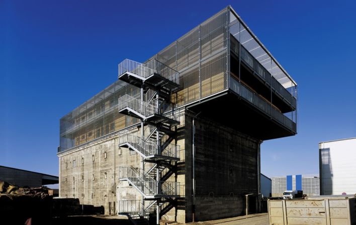 What to do with a bunker that's too expensive to bulldoze but not near a residential neighborhood? <a  target="_blank" target="_blank">Index Architekten</a> hit on the idea of creating a large wooden box atop the WWII building. It houses artists' studios and the Institute for New Media.