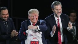 Liberty University President Jerry Falwell, Jr. (R) presents Republican presidential candidate Donald Trump with a sports jersey after he delivered the convocation in the Vines Center at the university  January 18, 2016 in Lynchburg, Virginia.