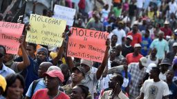 Demonstrators march in the streets of Port-au-Prince, capital of Haiti, on January 25, 2016.