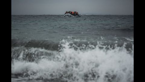 Refugees and migrants onboard a dinghy approach the Greek island of Lesbos after crossing the Aegean Sea from Turkey on Sunday, January 3.