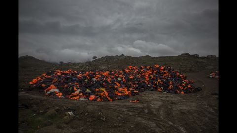 Piles of life jackets used by refugees and migrants to cross the Aegean Sea from the Turkish coast remain stacked on the shore of Lesbos on Thursday, January 7.