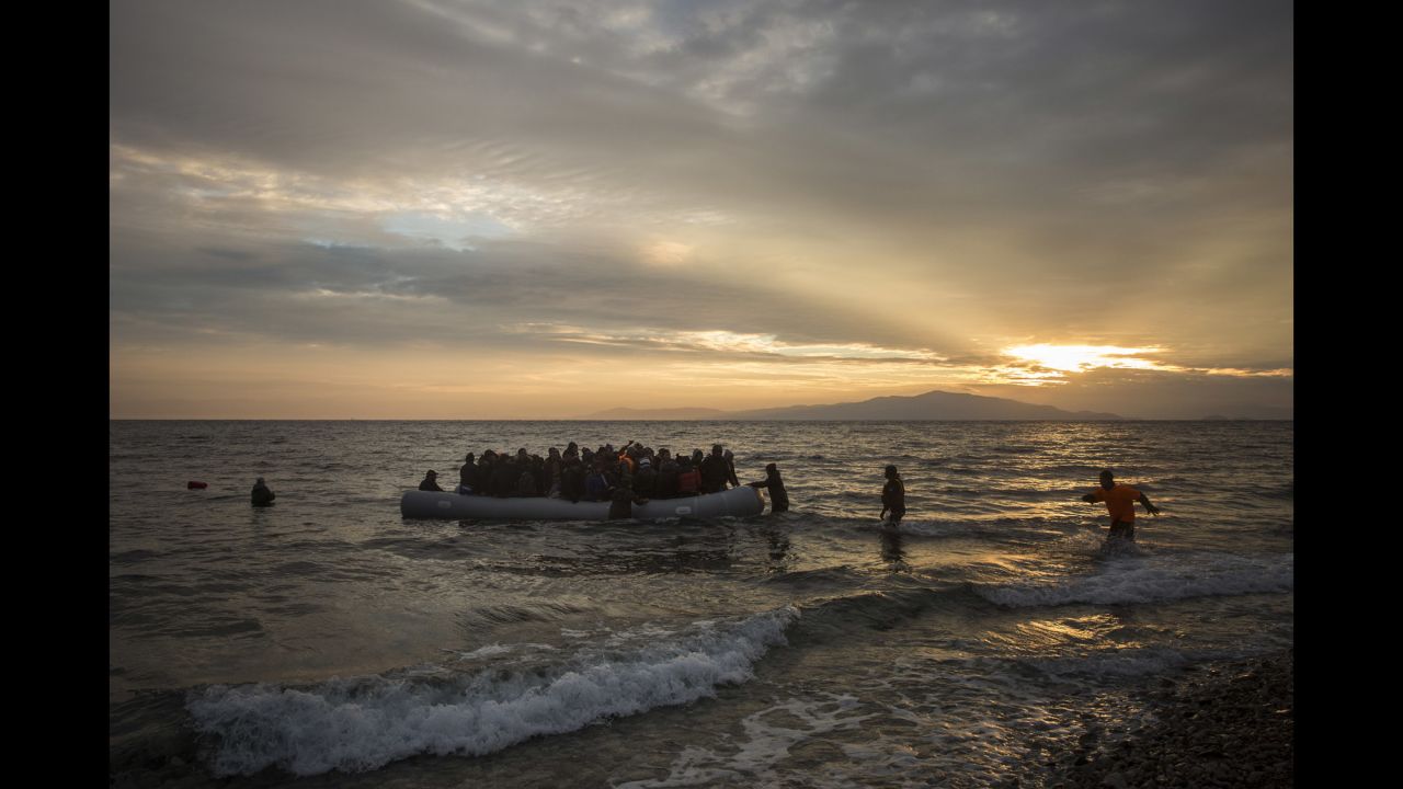 Volunteers rush to help refugees and migrants as they arrive on the shore of Lesbos on January 3.
