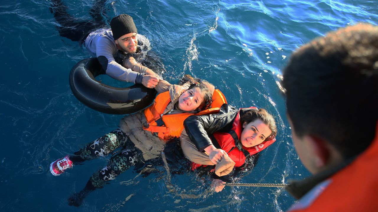 The Turkish coast guard helps refugees near Aydin, Turkey, after their boat toppled en route to Greece in January 2016.