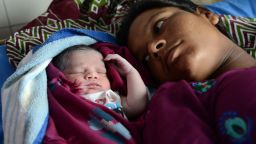 Indian mother Sonia (R) looks on as her newborn baby girl sleeps at a government hospital in Amritsar on July 11, 2013, on the occasion of World Population Day. Africa and Asia are the continents that will see the fastest urban population growth in the next 40 years, a UN report said earlier in the year noting that India and China are leading the surge. The Earth's population is expected to roughly triple by 2050 compared to a century earlier. It stood at three billion in 1950, reached seven billion in 2011 and is likely to reach about 9.5 billion by 2050 -- a rise that will occur especially in the poorest countries, according to UN estimates. AFP PHOTO/NARINDER NANU        (Photo credit should read NARINDER NANU/AFP/Getty Images)