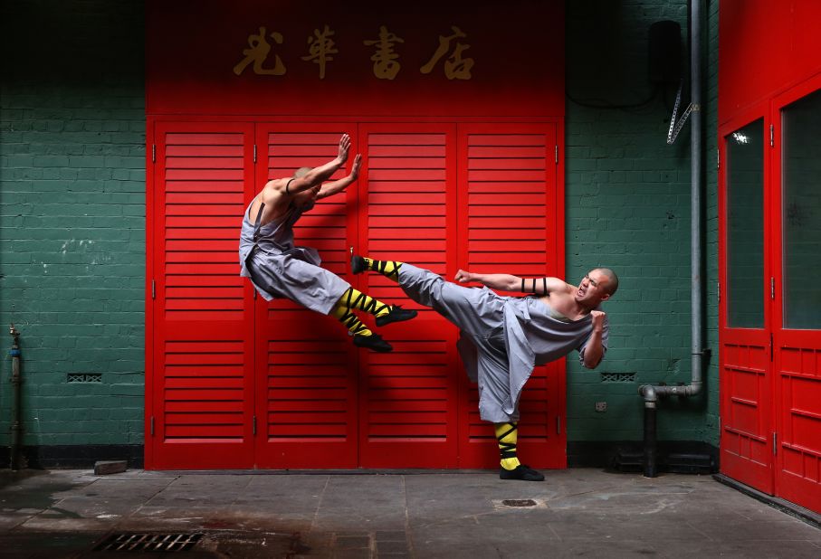 Shaolin monks pose for a photo in London's Chinatown. Drewell attempts to emulate their athleticism in his routine but admits it's hard. "I try to do a kind of high kick while they are fighting," he says. "I tried to do it on the horse but my feet don't go so high -- but I try!"<br />