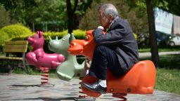 An elderly man sits on a hobby horse at a residential area in Beijing on May 4, 2015.      AFP PHOTO/ WANG ZHAO        (Photo credit should read WANG ZHAO/AFP/Getty Images)