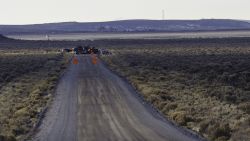 Law Enforcement Agencies operate a checkpoint on a road as a containment strategy surrounding the Malheur Wildlife Refuge January 27, 2016 near Burns, Oregon. 
Although leaders of a group that illegally occupied the federal buildings were arrested, many armed occupants still on site have said that they intend to stay despite repeated requests to leave. The iconic wildlife tower of the buildings is visible in the upper left of this photograph.  / AFP / Rob Kerr        (Photo credit should read ROB KERR/AFP/Getty Images)