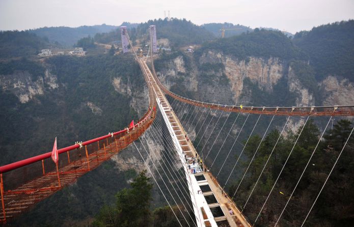 Workers recently began installing glass on what will be the world's longest glass-bottom bridge. Due to open in May, it's 430 meters long, six meters wide and hovers over a 300-meter vertical drop in China's Hunan province. 