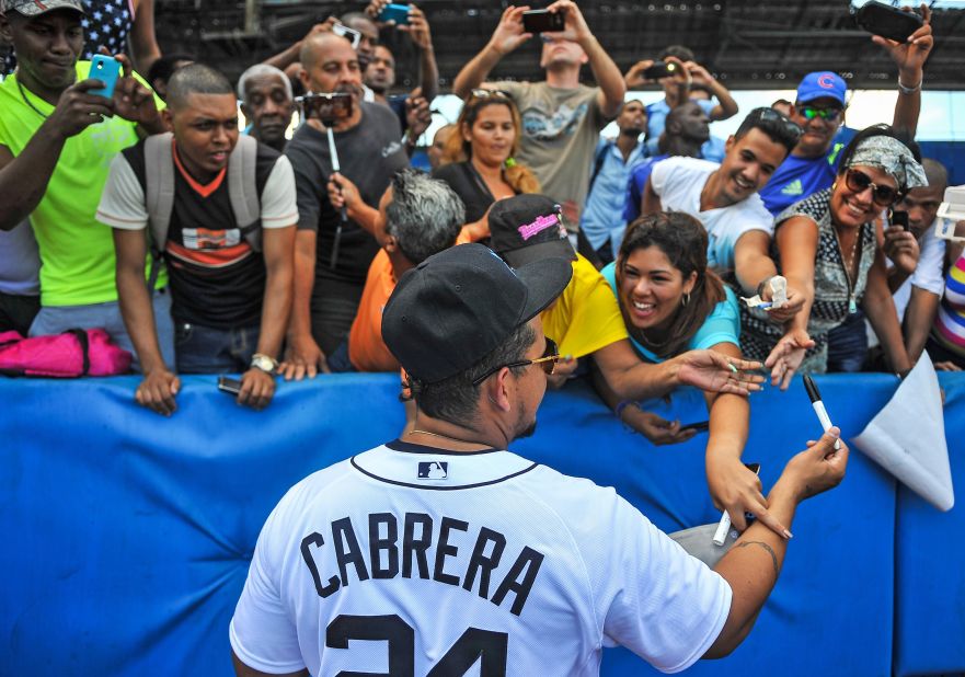 The group met fans at the Latin American Stadium in Havana. Here, Venezuela's Miguel Cabrera signs autographs.