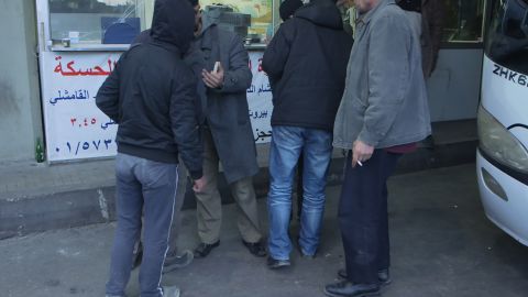 Passengers smoke at the ticket office in Beirut's Charles Helou bus station. Cigarettes are banned by ISIS, so this may be their last for a while.