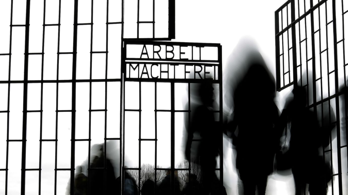 People in Oranienburg, Germany, walk through the gate of the Sachsenhausen concentration camp on Wednesday, January 27. It was International Holocaust Remembrance Day. The phrase on the gate translates to "Work sets you free."