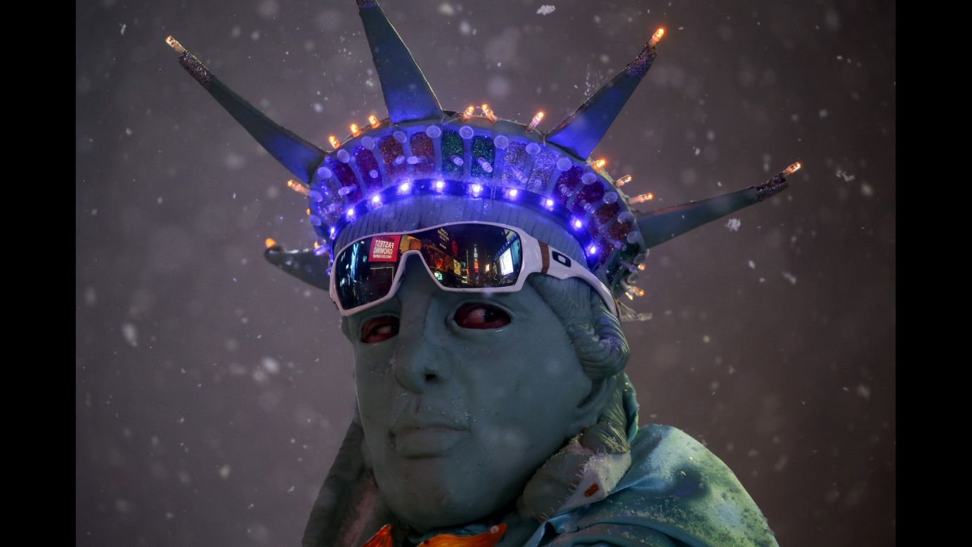 A man poses as the Statue of Liberty during a snowstorm in New York's Times Square on Saturday, January 23.