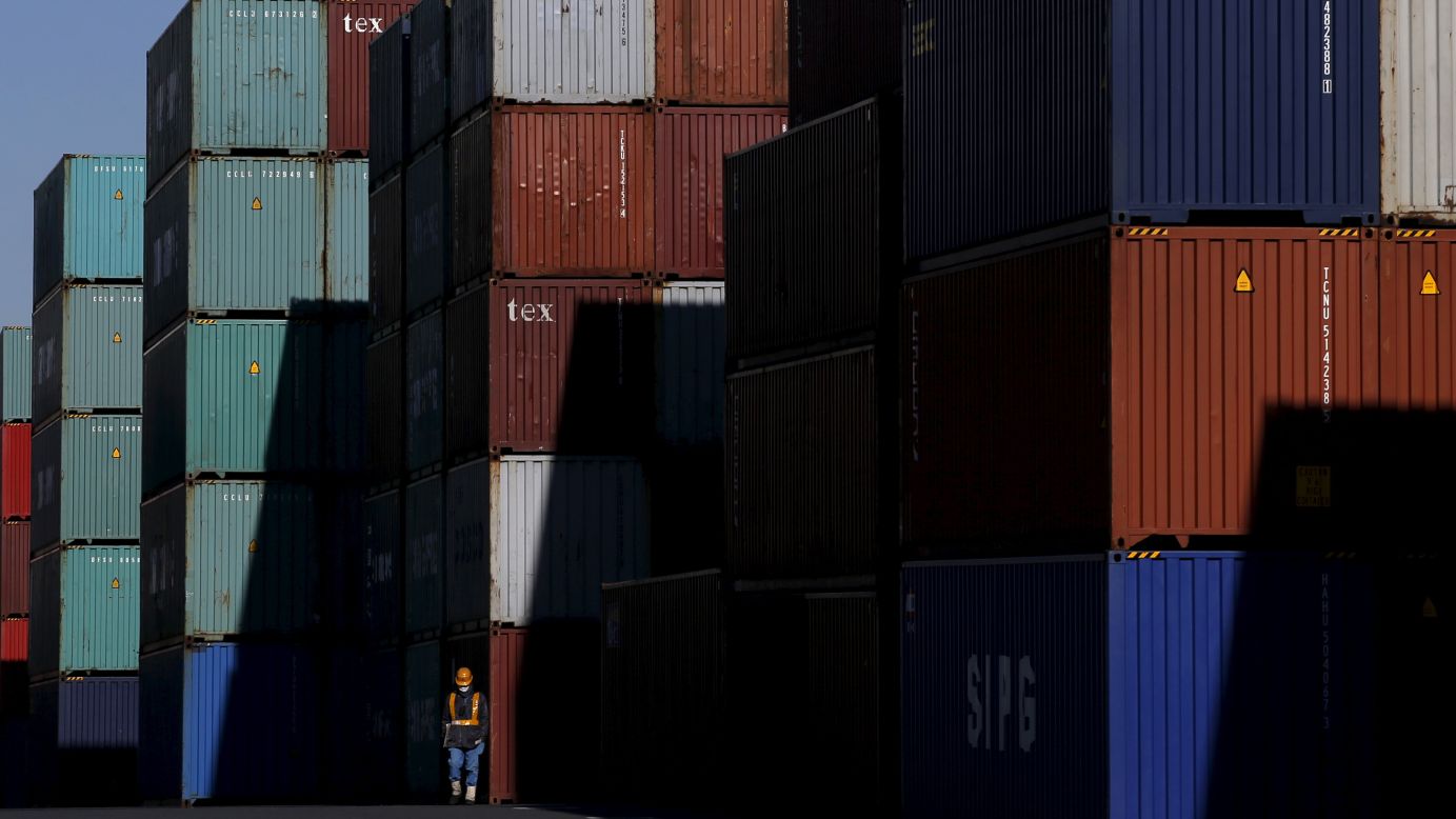 A worker walks through a container area at a port in Tokyo on Monday, January 25. 