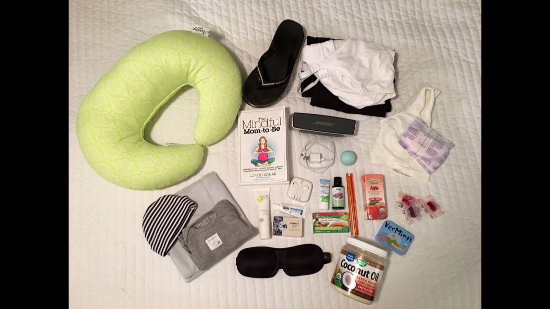 Deanna Neiers maternity bag includes: Music player, coconut oil for massage, lavender oil, arnica gel, snacks, nursing bra and pads, nursing pillow, comfortable clothes to wear at the hospital and on her return home, soft swaddle blanket for the baby, clothes for the baby and a hat for the baby.