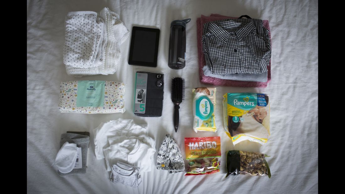 Joanna Laurie's bag includes: diapers, clothes for the baby, clothes for mom, snacks, towel for mom, toiletries, maternity pads, iPad, water bottle, medical notes, a blanket and a maternity TENS machine for pain.