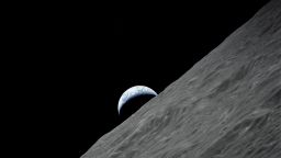 The crescent Earth rises over the moon's horizon in this photograph taken from the Apollo 17 spacecraft in December 1972.