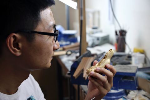 With demand for ivory carving falling, Li Jiulong, the older Li's student,  is undertaking a master's degree which sees him working with lacquer -- a traditional colored finish applied to wood.<br />