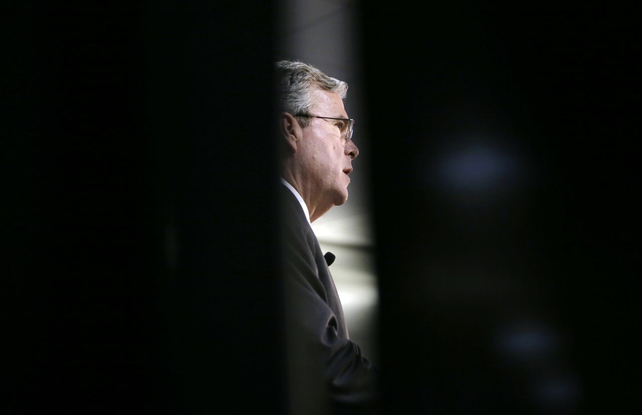 Republican presidential candidate Jeb Bush is seen through a curtain as he speaks at an event in Des Moines, Iowa, on Wednesday, January 27.