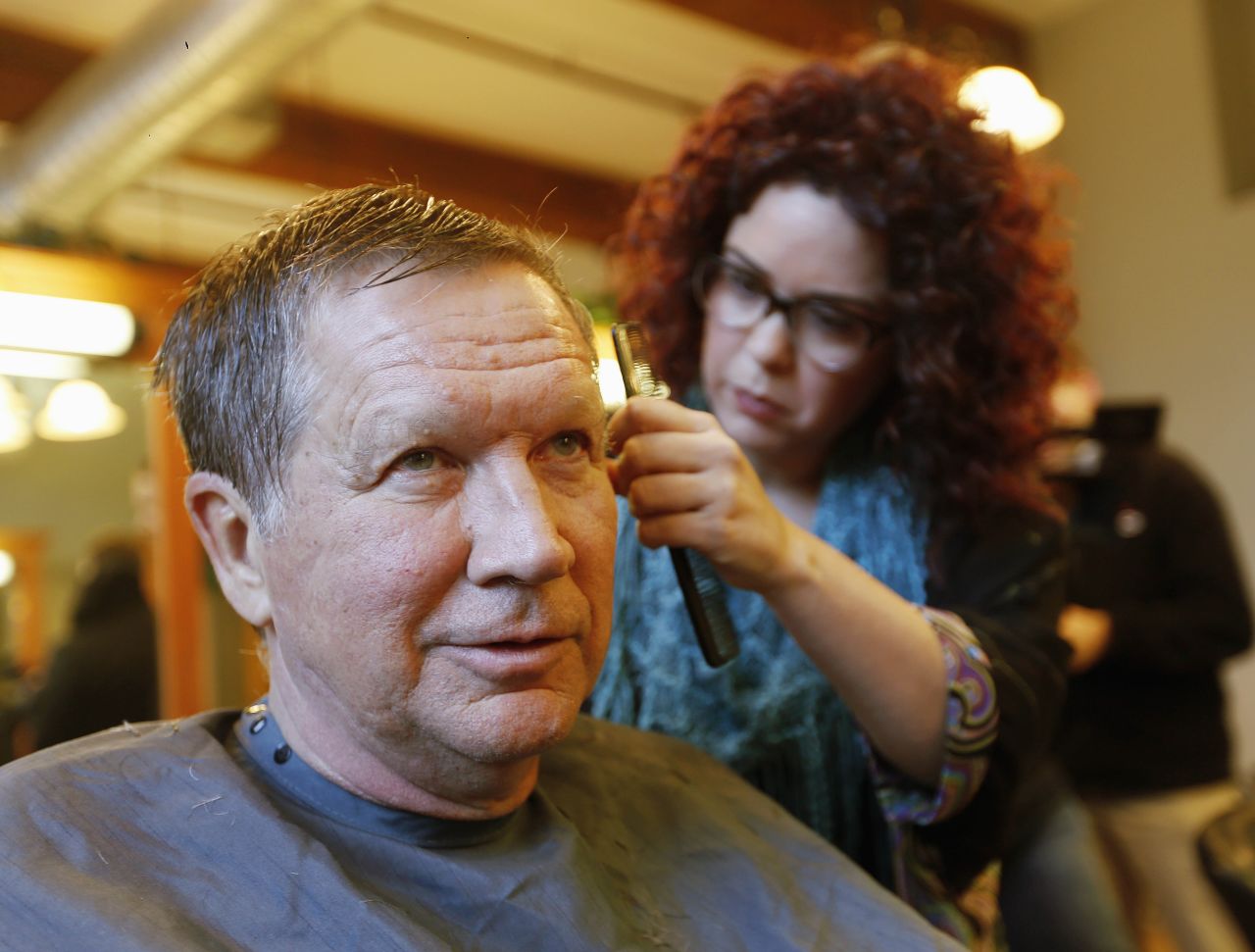 Ohio Gov. John Kasich, a Republican presidential candidate, has his hair cut in Manchester, New Hampshire, on Monday, January 25.