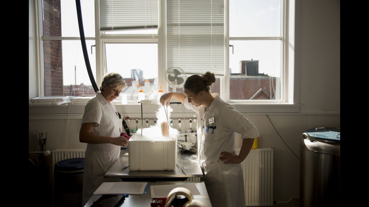 Lab technicians Dorte Jensen, left, and Marianne B. Rohde work at Cryos International, a sperm bank in Aarhus, Denmark, in September.