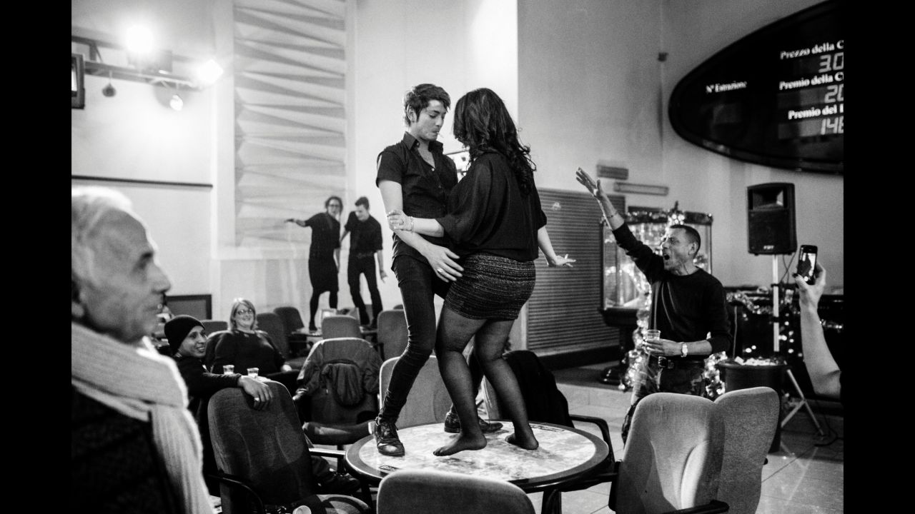 Dario dances on a table at the bingo hall.