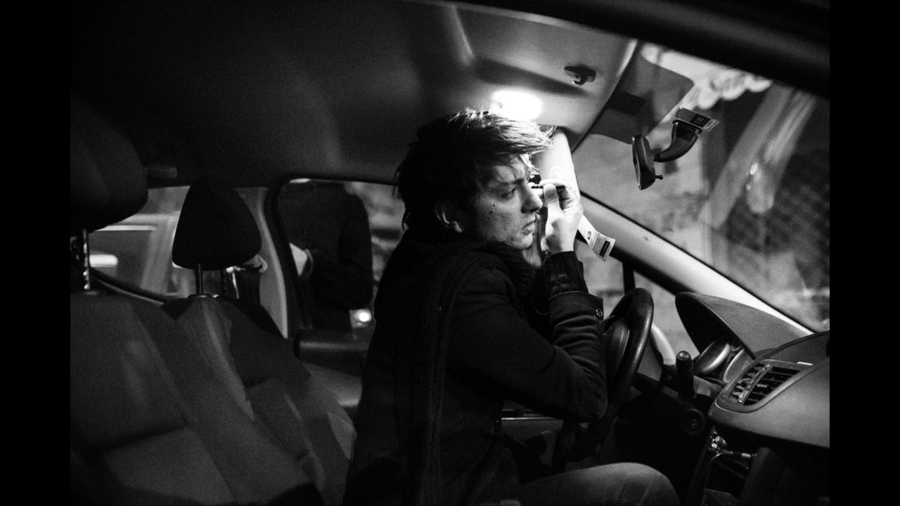Dario does his makeup in a car.