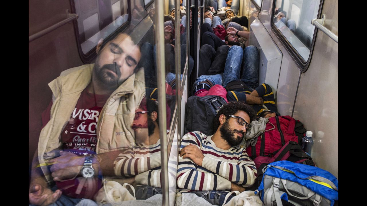 Somar, bottom right, rests during a train ride to Serbia. Italian photographer Alessio Mamo documented Somar and his two sisters as they traveled through numerous countries to Germany.