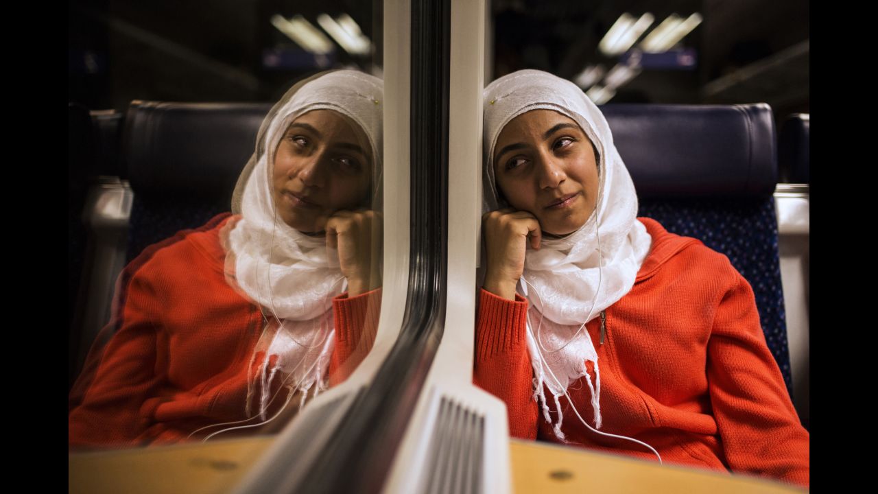 Lubna cries on a train. Only in Germany do Somar's sisters realize they might never return to Syria.