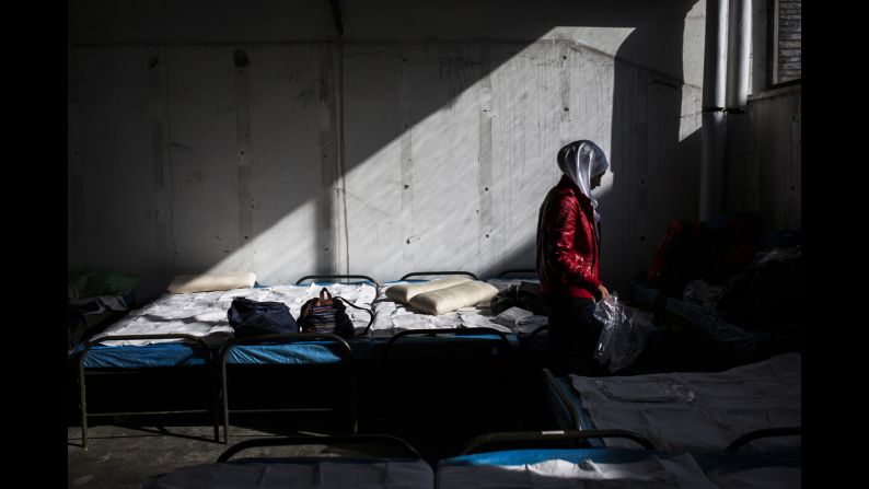 Salsabil fixes beds inside a transit refugee camp.