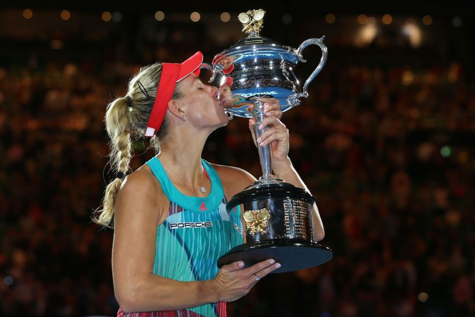 Angelique Kerber of Germany kisses the Daphne Akhurst Trophy after winning the Australian Open women's singles title in a stunning upset of Serena Williams in Melbourne.