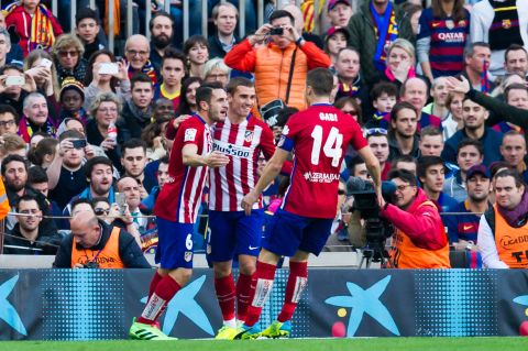 Koke (left) gets the plaudits from teammates Antoine Griezmann (C) and Gabi after scoring a fine opener for Atletico.